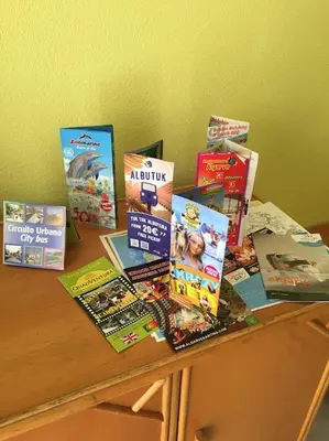 a bunch of books sitting on top of a table at Happydreams apartment in Albufeira in Albufeira