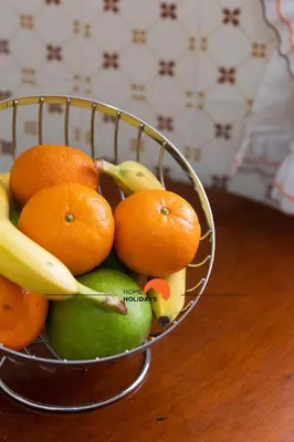 a bowl of fruit with oranges and bananas on a table at #132 Velamar 414 by Home Holidays in Albufeira