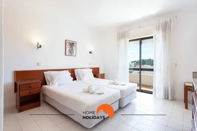 a hotel room with two beds and a window at #132 Velamar 414 by Home Holidays in Albufeira
