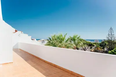 a bedroom with a large bed and a large window at Penthouse S.Jorge Seaview T4 in Quarteira