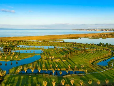 an aerial view of a golf course with the ocean at Outstanding Condo- Beach, Pool & Golf by BeCherish in Galé