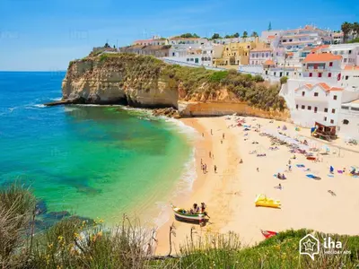 a group of people on a beach near the ocean at Outstanding Condo- Beach, Pool & Golf by BeCherish in Galé