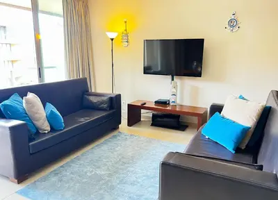 a living room with a couch and a tv at Outstanding Condo- Beach, Pool & Golf by BeCherish in Galé