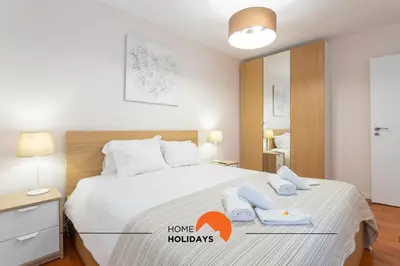 a bedroom with a large white bed with two pillows at #165 Liberdade 105 by Home Holidays in Albufeira