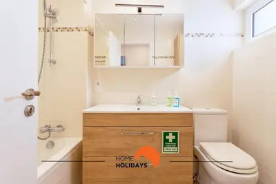 a bathroom with a sink and a toilet and a mirror at #165 Liberdade 105 by Home Holidays in Albufeira