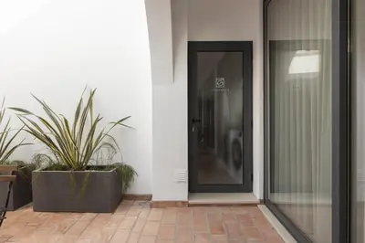 a black door on a building with plants at Madalena Village 3 - City centre by HD PROPERTIES in Faro