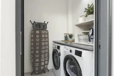 a laundry room with a washer and dryer at Madalena Village 3 - City centre by HD PROPERTIES in Faro