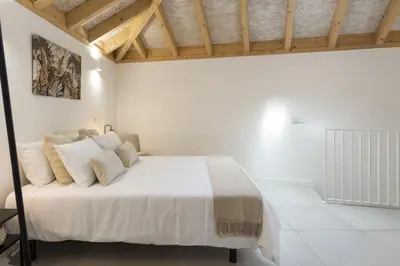 a white bedroom with a large bed with white pillows at Madalena Village 3 - City centre by HD PROPERTIES in Faro