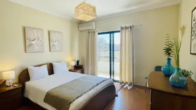 a bedroom with a bed and a large window at Vale Pedras by Check-in Portugal in Albufeira