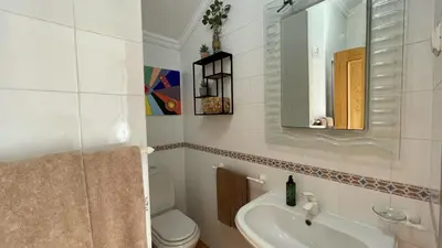 a bathroom with a sink and a toilet and a mirror at Vale Pedras by Check-in Portugal in Albufeira
