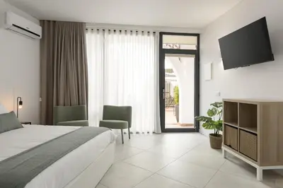 a bedroom with a bed and a sliding glass door at Madalena Village 4 - City centre by HD PROPERTIES in Faro