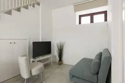 a living room with a couch and a tv at Madalena Village 2 - City centre by HD PROPERTIES in Faro