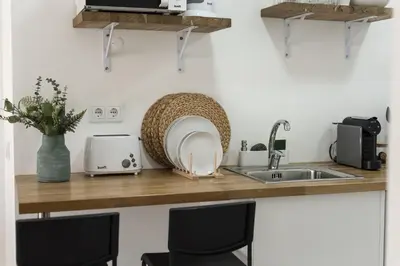 a kitchen counter with a sink and a microwave at Madalena Village 6 - City centre by HD PROPERTIES in Faro