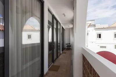 an internal corridor of a building with glass doors at Madalena Village 6 - City centre by HD PROPERTIES in Faro