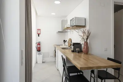 a kitchen with a wooden counter top in a room at Madalena Village 7 - City centre by HD PROPERTIES in Faro