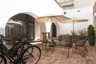 a group of bikes parked on a patio with umbrellas at Madalena Village 7 - City centre by HD PROPERTIES in Faro