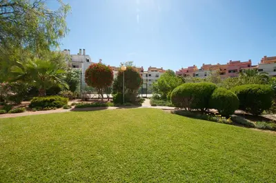 a park with a lawn and trees and buildings at Ondas Verdes by OCvillas in Albufeira