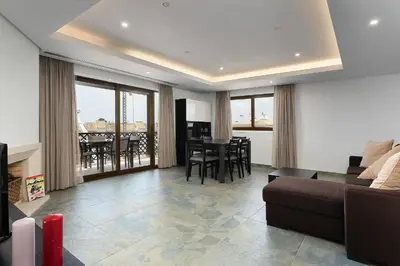 a living room with a couch and a table at Elegance Apartment W/ Balcony & Pool by LovelyStay in Albufeira