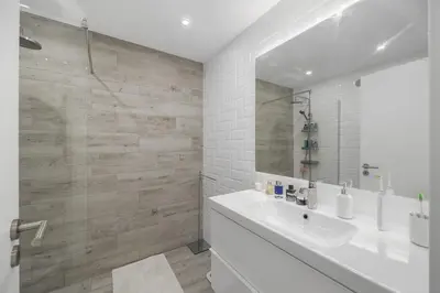 a white bathroom with a sink and a mirror at Silver Lux Studio 2 - City Center by HD PROPERTIES in Vilamoura