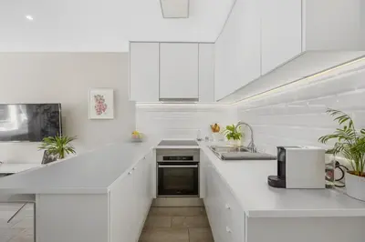 a white kitchen with a sink and a microwave at Silver Lux Studio 2 - City Center by HD PROPERTIES in Vilamoura