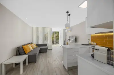 a kitchen and a living room with a couch at Silver Lux Studio 1 - City Center by HD PROPERTIES in Vilamoura