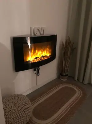 a living room with a fireplace on the wall at Happy Sunrise in Albufeira