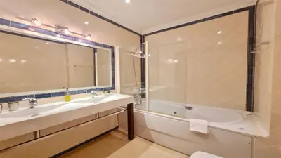 a bathroom with a tub and a sink and a shower at Villa Nuki- CleverDetails, quiet location, sleeps 8, private pool in Vilamoura