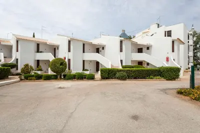 a row of white buildings with a parking lot at Centralgarve - Premium Apartment in the Center of Vilamoura - Cota10 in Vilamoura