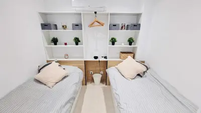 two beds in a room with white walls at Your dream Getaway Awaits in Vale do Lobo in Almancil