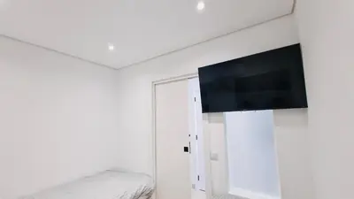 a bedroom with a flat screen tv on a wall at Your dream Getaway Awaits in Vale do Lobo in Almancil
