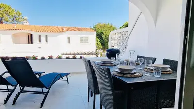 a black table and chairs on a patio at Your dream Getaway Awaits in Vale do Lobo in Almancil