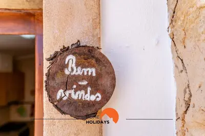 a plate with a croissant and a glass of orange juice at #161 T1 Casa dos Avós by Home Holidays in Paderne