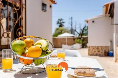 a living room with a red couch and a table at #161 T1 Casa dos Avós by Home Holidays in Paderne