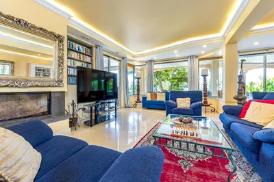a living room with blue couches and a tv at Villa Casa do Monte in Albufeira