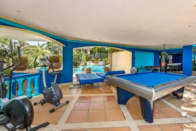 a pool room with a pool table and fitness equipment at Villa Casa do Monte in Albufeira