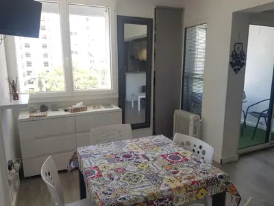 a dining room with a table and some chairs at Studio Praia de Quarteira in Quarteira