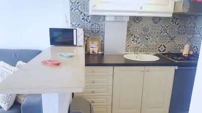 a small kitchen with a sink and a counter at Studio Praia de Quarteira in Quarteira