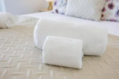two towels sitting on top of a bed at Terraços de Quarteira Ethnic by Real Properties in Quarteira