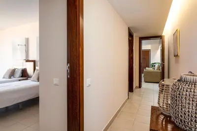 a bedroom with a bed and a living room at TAC - Salgados Beach Prime Pool Resort in Guia