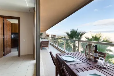 a balcony with a table and a view of the ocean at TAC - Salgados Beach Prime Pool Resort in Guia