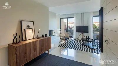 a living room with a television and a room with a couch at Apartment Micaela in Vale do Lobo