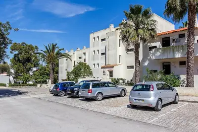a row of cars parked in front of a building at Blue Sea in Albufeira