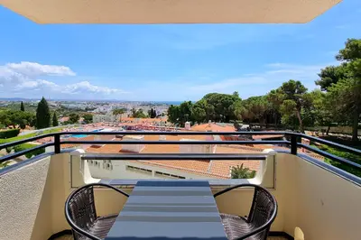 a balcony with a table and chairs and a view at Blue Sea in Albufeira