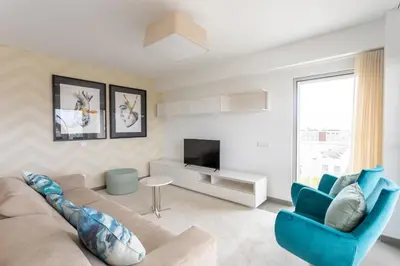 a living room with a couch and a tv at Glamour Apartment With Pool in Albufeira