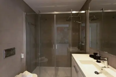 a bathroom with a shower and a sink and a toilet at Glamour Apartment With Pool in Albufeira