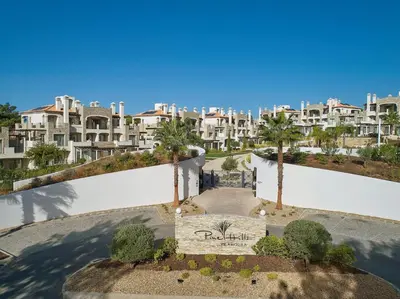 an aerial view of a building with palm trees at Vilamoura Pine Hills Luxury Apartment in Quarteira