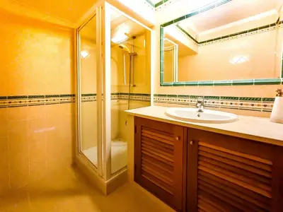 a bathroom with a sink and a shower and a mirror at FLH Quinta das Salinas Triplex with Balcony in Vale do Lobo