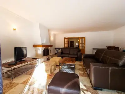 a living room with a couch and a tv at FLH Quinta das Salinas Triplex with Balcony in Vale do Lobo