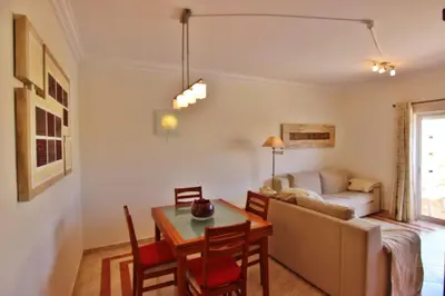 a living room with a table and a couch at ViaMar Apartment in Vilamoura