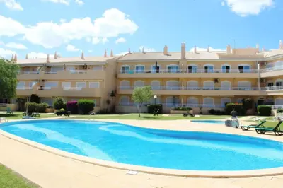 a swimming pool in front of a building at ViaMar Apartment in Vilamoura
